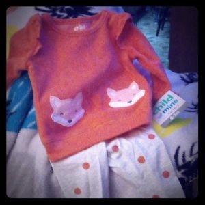 Pink shirt with foxes on it and ruffles on the sho